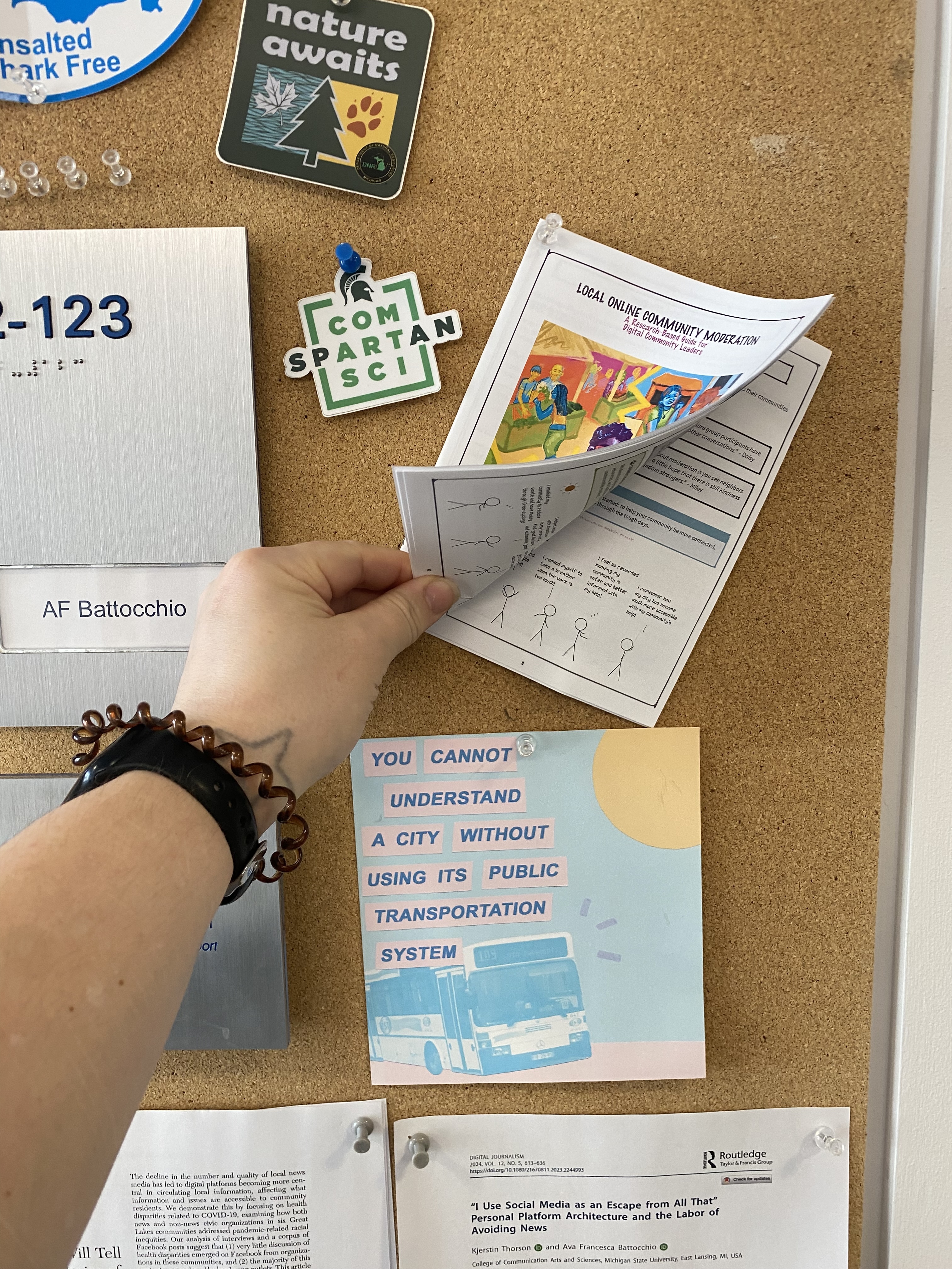 Photo of example of self-printed zine on bulletin board next to AF's office